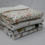 Vier wiegdekens opgestapeld.